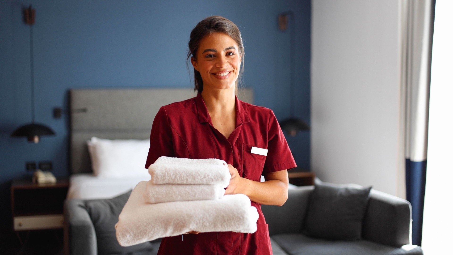 Portrait of a cheerful, smiling hotel maid
